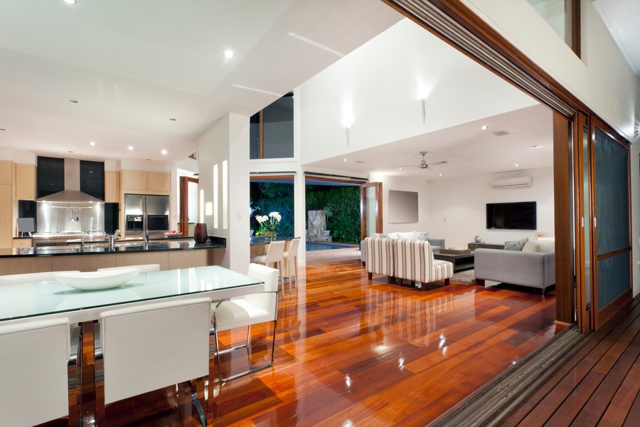 Image is of a modern home with a hardwood floor and bright ceiling lighting.