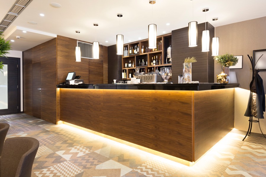 Image is of a bar or nook in a modern home with beautiful lighting on the ceiling.