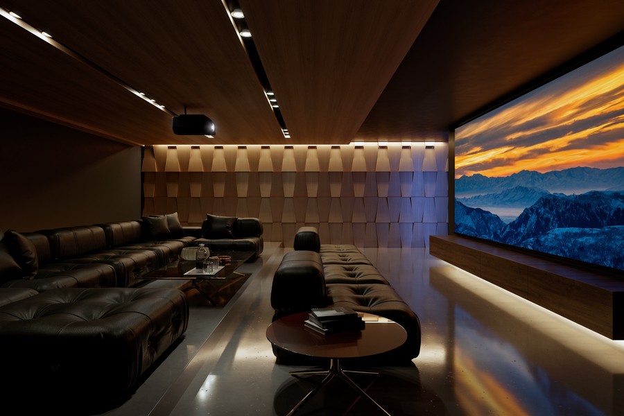 A home theater with sectionals, acoustic paneling, a Sony projector, and a large movie screen.
